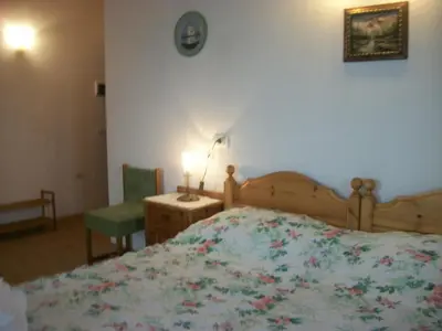a bedroom with a bed and a table and a lamp at Agri-park Casa Miramonte in Ronzone