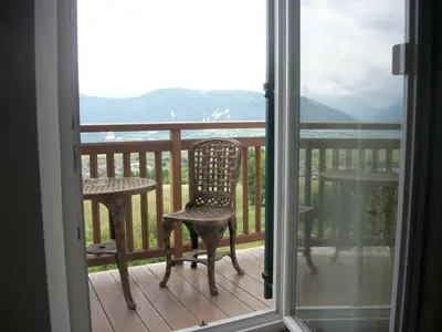 a balcony with a chair and a table with a view at Agri-park Casa Miramonte in Ronzone