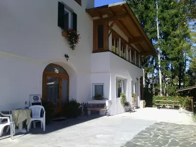 a white building with a porch and a balcony at Agri-park Casa Miramonte in Ronzone