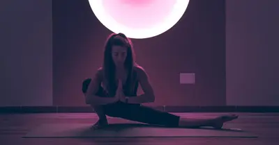 a woman sitting in a yoga pose under a moon at Vegan Hotel La Vimea in Naturno