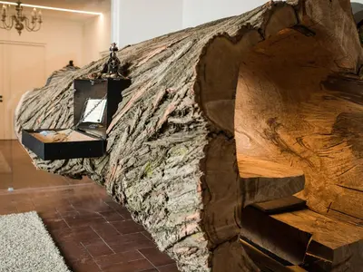 a bedroom with a bed with a wooden headboard at Garni Hotel Katzenthalerhof in Lana
