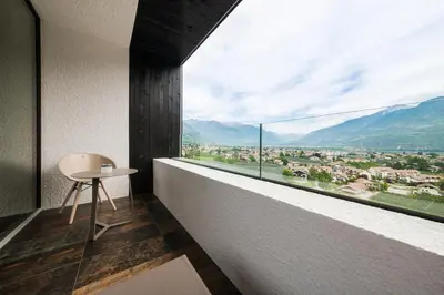 a room with a table and a large window at Garni Hotel Katzenthalerhof in Lana