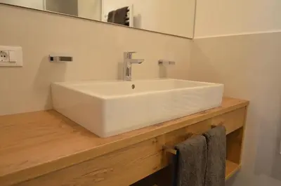 a bathroom with a white sink and a mirror at Villa Paröis in La Valle
