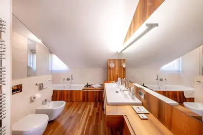 a bathroom with two sinks and two mirrors at Frühmesserhaus Refugium zu Sanct Kassian in Lagundo