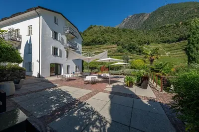 a view of a building with a mountain in the background at Frühmesserhaus Refugium zu Sanct Kassian in Lagundo