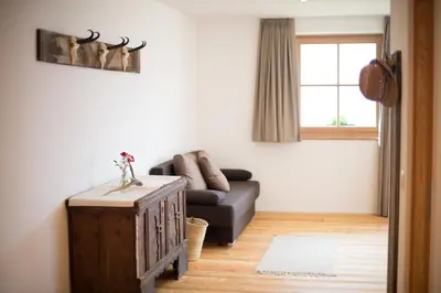 a living room with a couch and a table at Ferienwohnung - THOLER in Lagundo