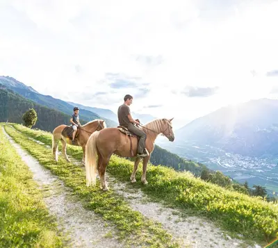 two people riding horses on a dirt road at Ferienwohnung - THOLER in Lagundo