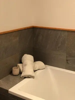 a bath tub with towels sitting on top of it at Ferienwohnung - THOLER in Lagundo