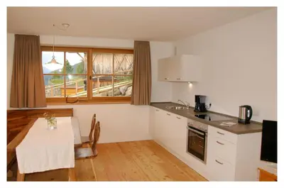 a kitchen with a table and a dining room at Ferienwohnung - THOLER in Lagundo