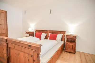 a bedroom with two beds with red pillows at Ferienwohnung - THOLER in Lagundo