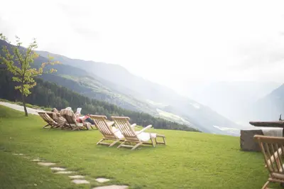 a group of people sitting in chairs on a hill at Ferienwohnung - THOLER in Lagundo