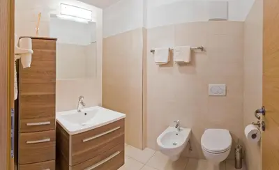 a bathroom with a toilet and a sink at Ferienwohnungen St. Michael in Appiano sulla Strada del Vino