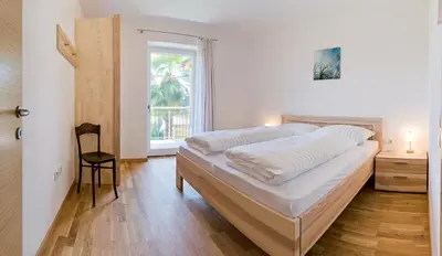 a bedroom with a large bed and a window at Ferienwohnungen St. Michael in Appiano sulla Strada del Vino