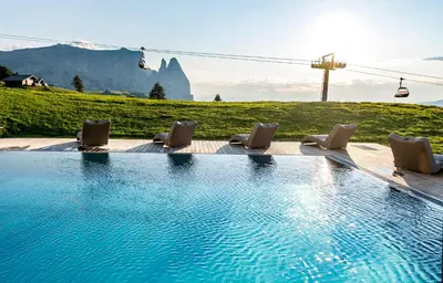 a bathroom with two sinks and a shower at Hotel Santner Alpine Sport & Relax in Alpe di Siusi