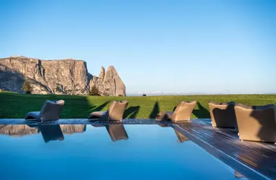 a building on top of a snow covered mountain at Hotel Santner Alpine Sport & Relax in Alpe di Siusi