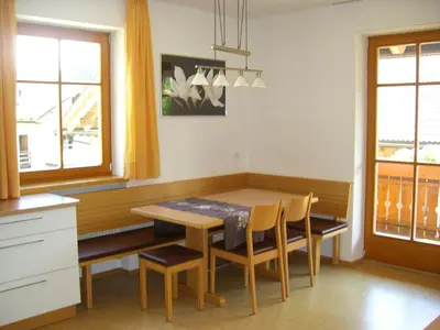 a kitchen with a dining room table and chairs at Stockerhof in San Lorenzo di Sebato