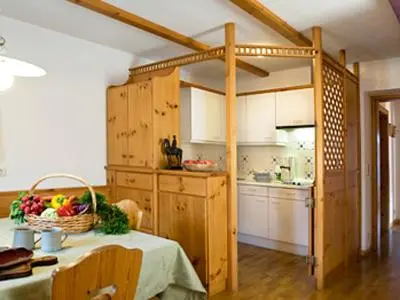a kitchen with a table with a basket of fruit on it at Residence Kampidell in Siusi