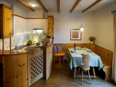 a kitchen with a table and a sink in it at Residence Kampidell in Siusi