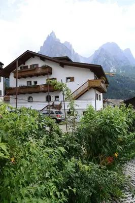 a white house with mountains in the background at Residence Kampidell in Siusi