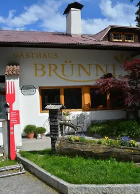 a building with a sign that readsennis brunch at Brünnl's Försterhütte in Parcines