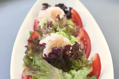 a white plate with a salad with tomatoes and cheese at Das Alte Rathaus in Egna