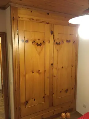 a wooden cabinet in a room with a ceiling at Casa Italo in Canazei