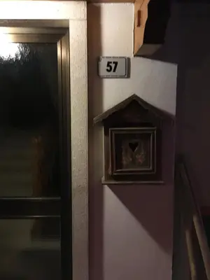 a door with a clock on it with the number at Casa Italo in Canazei