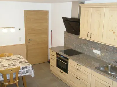 a kitchen with a sink and a stove top oven at Boarhof Appartaments in San Giacomo Val di Vizze