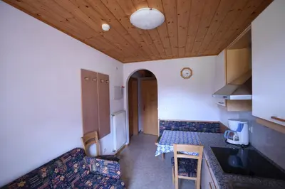 a kitchen with a table and a counter top at Boarhof Appartaments in San Giacomo Val di Vizze
