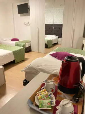 a tea kettle and a plate of food on a table at Hotel B&B Lorenzini Ski in Selva di Cadore
