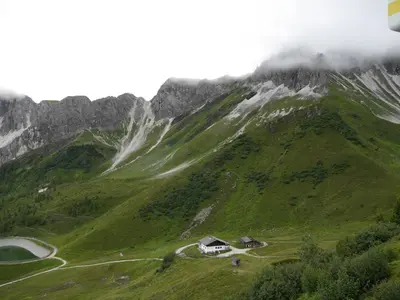 a snow covered mountain with two houses on it at Edelweisshütte Ladurns in Fleres