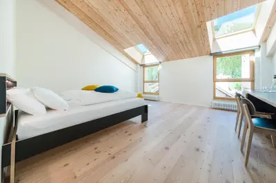 a bedroom with a bed with a wooden ceiling at Zum Hirschen Boutique Hotel Val di Non in Unsere Liebe Frau im Walde