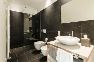 a bathroom with a sink and a toilet at Zum Hirschen Boutique Hotel Val di Non in Unsere Liebe Frau im Walde