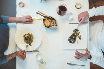 a group of people eating food on a table at Zum Hirschen Boutique Hotel Val di Non in Unsere Liebe Frau im Walde