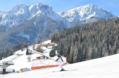 a person is skiing down a snow covered mountain at Apartments Oberpichlhof in Valdaora