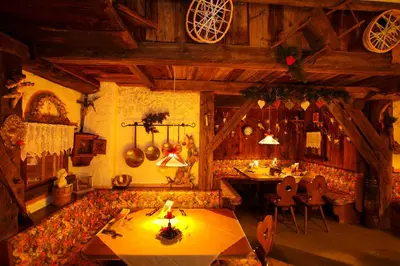 a living room with a couch and tables in it at Hotel Al Sonnenhof in San Vigilio Di Marebbe