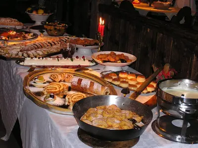 a table with a buffet of food on it at Hotel Al Sonnenhof in San Vigilio Di Marebbe