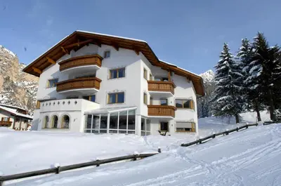 a large building in the snow with snow at Residence Villa Funtanes in Selva di Val Gardena