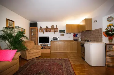 a kitchen with a couch and a table in a room at Cesa Sule de Sot in Ortisei