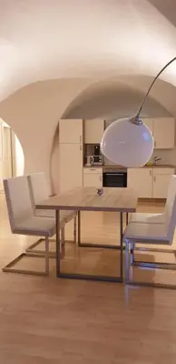 a dining room with a table and two chairs at Ansitz Strengherrnhof in Caldaro