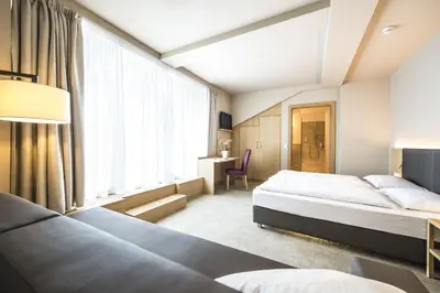 a hotel room with two beds and a window at Hotel CampingPark Steiner in Laives