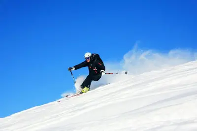 a person is skiing down a snow covered slope at Hotel Ciasa Salares in San Cassiano