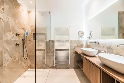 a bathroom with a sink and a shower at Hotel Weingarten in Appiano sulla Strada del Vino