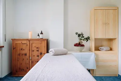 a bedroom with a bed and a wooden cabinet at Naturhotel Miraval in Perca