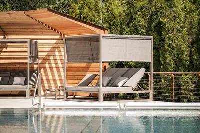 a gazebo sitting next to a swimming pool at Apartment Lodge Gasserhof in Bressanone