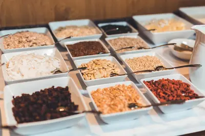 a table topped with trays of different types of nuts at Apartment Lodge Gasserhof in Bressanone