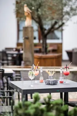 a table with wine glasses and bottles on it at Apartment Lodge Gasserhof in Bressanone
