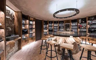 a wine tasting room with a table and stools at Apartment Lodge Gasserhof in Bressanone