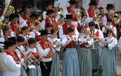 a group of people playing brass instruments in a orchestra at Dolasilla Park Hotel in Vigo di Fassa