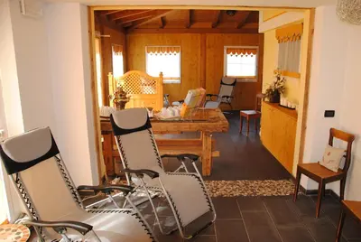 a living room with chairs and a table at Dolasilla Park Hotel in Vigo di Fassa